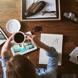 Woman entrepreneur drinking coffee studying business course