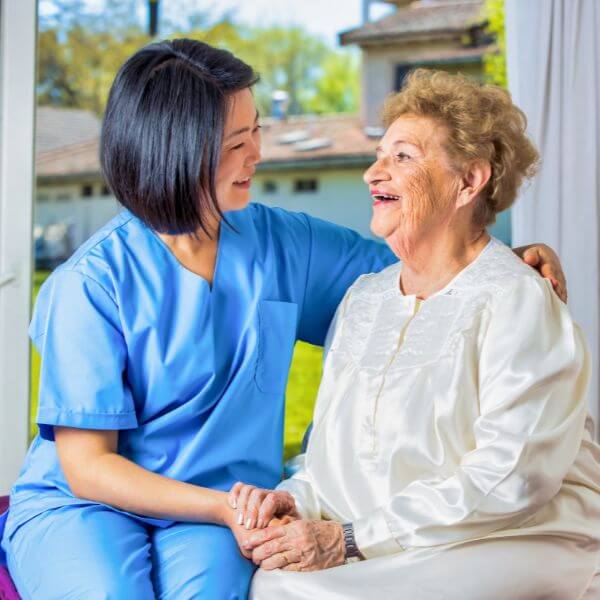 Nurse with elderly resident in care home
