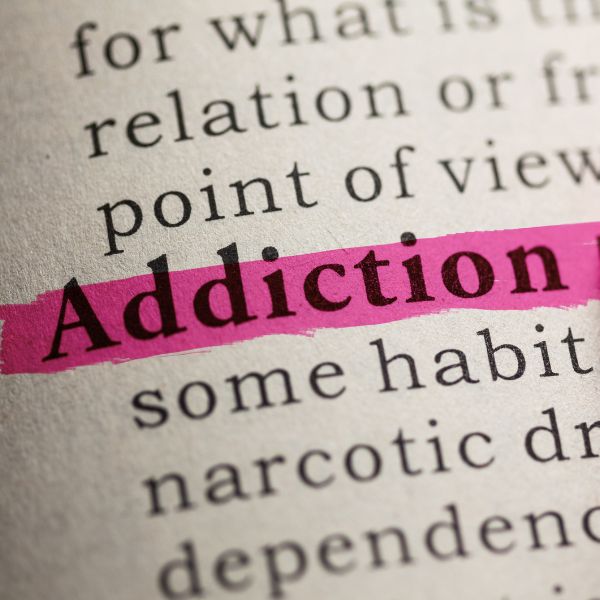 Dictionary page with "Addiction" highlighted in pink.